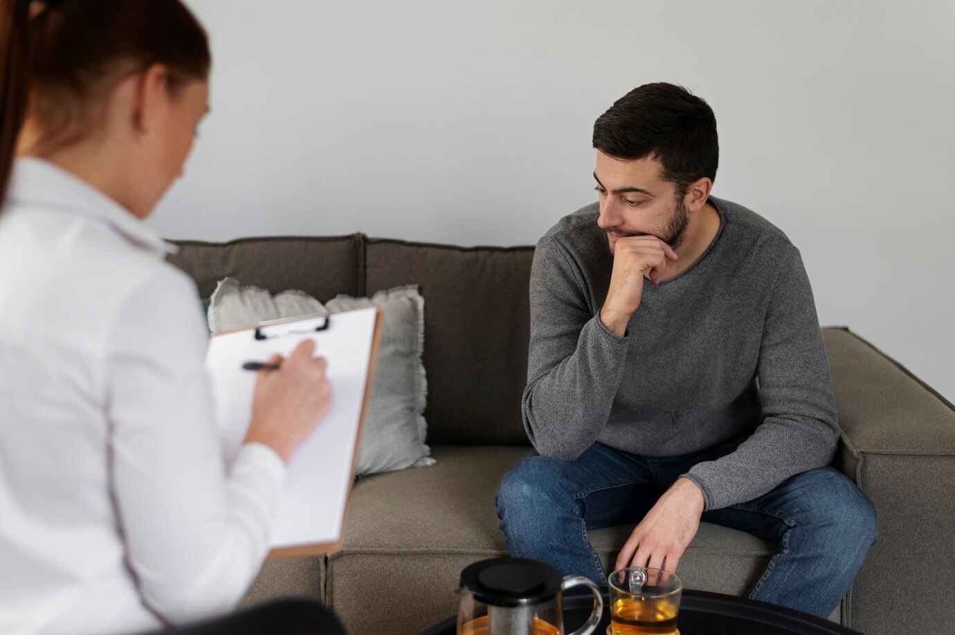 A man in conversation with a therapist during a rehab counselling session