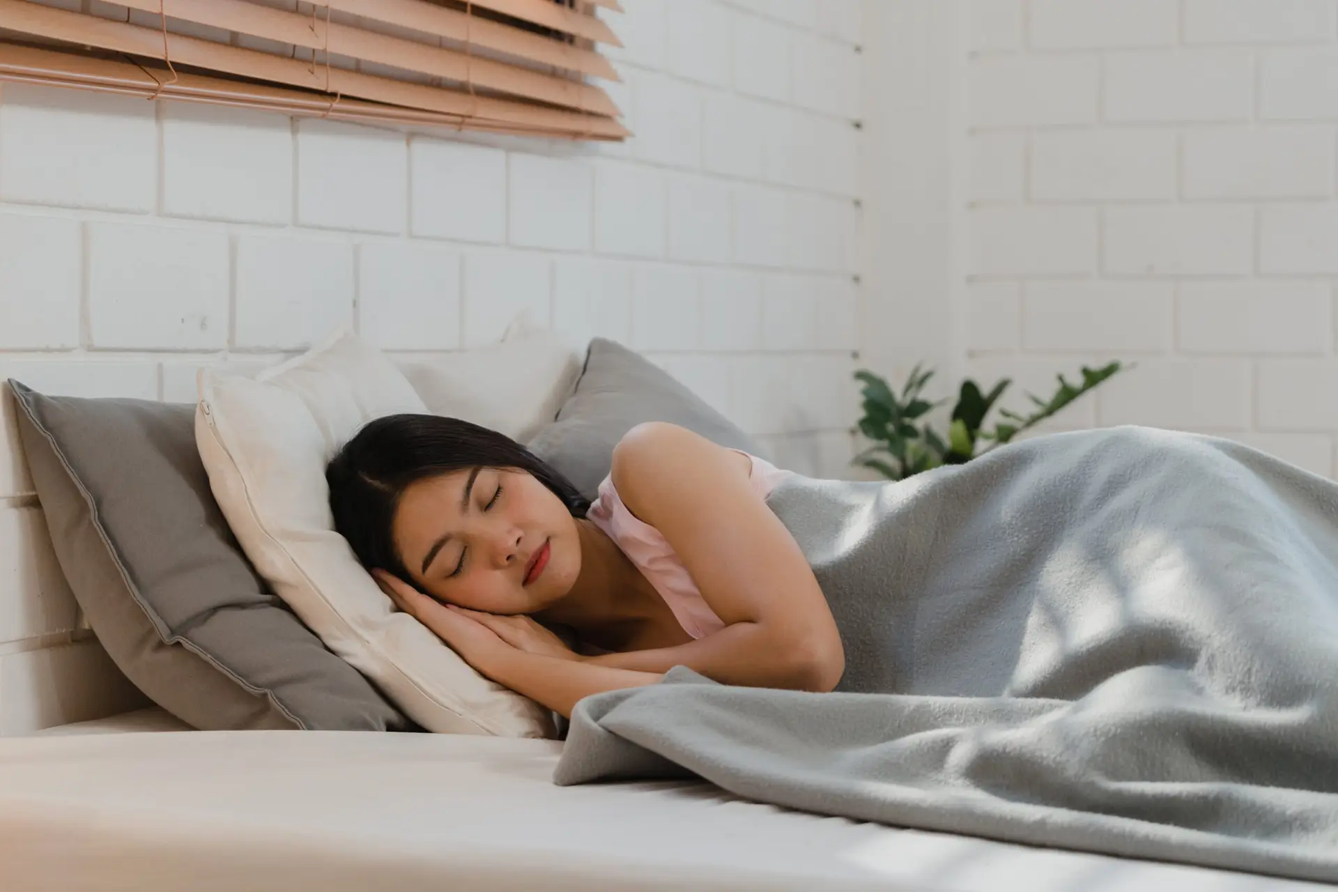 Woman resting peacefully at home, supporting nervous system recovery through sleep