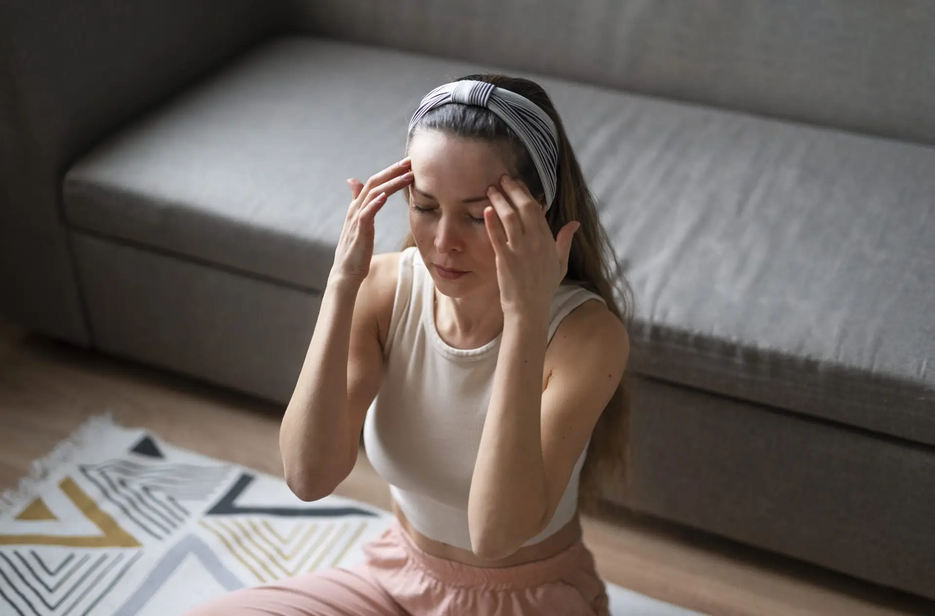 Woman practising a grounding body-awareness exercise