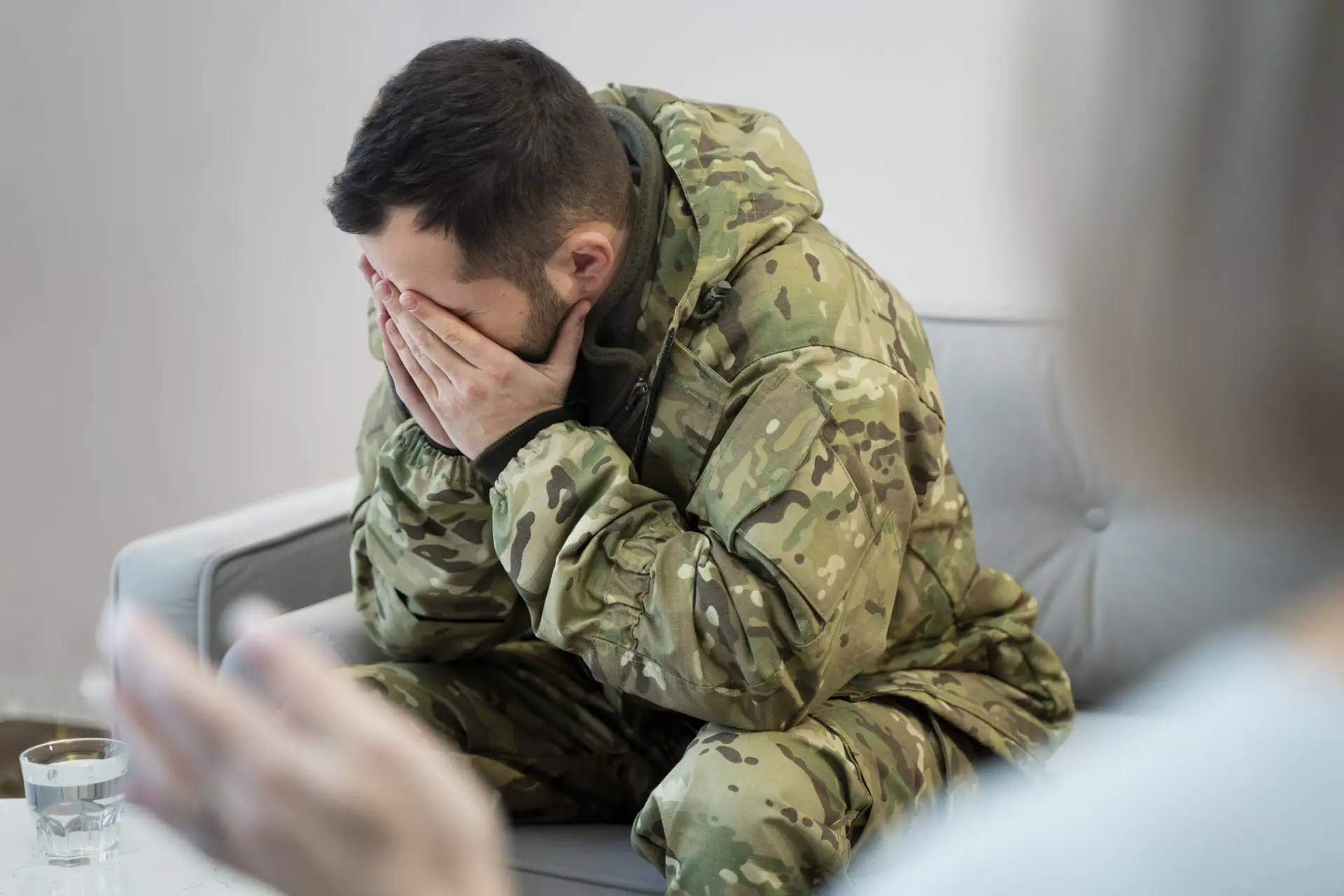 A soldier experiencing PTSD symptoms during a session with a psychologist